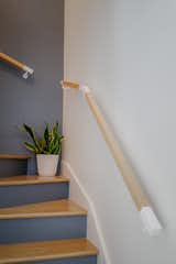 The existing staircase has undergone a transformation with new railings and pops of navy blue!