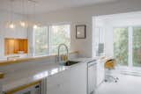 A central kitchen peninsula allows for large expenses of counterspace while acting as the back of the dning room's banquette. A 8" backsplash hides the mess when you're outside of the kitchen!