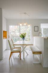 The dining room with its custom table and bench. The pendant is from Studio Botté, a Montreal-based lighting studio that uses upcycled materials to make their fixtures.