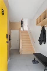 Robust finished plywood walls lead to storage under the stairs.