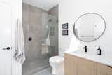 Natural stone tile custom shower and another skylight bring the outside in this bathroom.