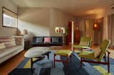 Another view of the Living room, where you can see a Finn Juhl loveseat with custom pillows, linen drapery, a vintage pottery collection and a tall cabinet from The Window.