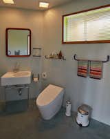 A teak mirror, 70s dead-stock hardware, and Missoni towels warm up the blue bathroom.