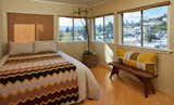 The same wood panelling was added to the guest bedroom to tie it into that wing of the house.  Custom drapery and pillows frame the view.  The flea market afghan throw echoes the Missoni towels and living room zig-zag pillows.