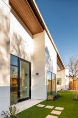 Exterior, Small Home Building Type, Butterfly RoofLine, Shingles Roof Material, Glass Siding Material, Concrete Siding Material, Metal Siding Material, Wood Siding Material, and House Building Type Corner Swooping Indoor-Outdoor Peninsula  Photo 5 of 39 in Homes in Little Forest Hills by F+E Design Architects