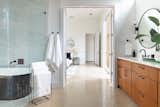 Bath Room, Ceiling Lighting, Wall Lighting, Soaking Tub, Porcelain Tile Wall, Ceramic Tile Wall, Engineered Quartz Counter, One Piece Toilet, Concrete Floor, Undermount Sink, Marble Wall, and Enclosed Shower  Photo 14 of 39 in Homes in Little Forest Hills by F+E Design Architects