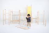 After Ame had spent 15 minutes with the design, we placed some beams and boards to observe his reaction. As he approached the beams, he picked up one and began carefully examining the holes. It was truly fascinating to witness a 1.5-year-old child analyzing something so attentively. He rotated the beam twice, closely observing the holes.