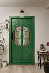 The entrance to the house is through this parrot green custom design parisian style door.