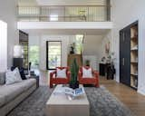 Bright and airy living room space featuring a recessed linear fireplace with an arcusstone surround. Contrasting built ins mimic the tones of the kitchen adjacent. 