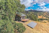 Tiny home / ADU. Exterior finishes are Nichiha cement siding, Casement windows, 10 foot wide glass wall, Ipe hardwood deck boards, Metal post and stainless steel cable handrail