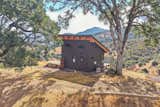 Tiny home / ADU. Exterior finishes are Nichiha cement siding, Casement windows, 10 foot wide glass wall, Ipe hardwood deck boards, Metal post and stainless steel cable handrail