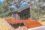 Tiny home / ADU. Exterior finishes are Nichiha cement siding, Casement windows, 10 foot wide glass wall, Ipe hardwood deck boards, Metal post and stainless steel cable handrail