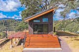 Tiny home / ADU. Exterior finishes are Nichiha cement siding, Casement windows, 10 foot wide glass wall, Ipe hardwood deck boards, Metal post and stainless steel cable handrail