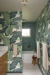 In the bathroom, we incorporated the iconic Banana Leaf Wallpaper from CW Stockwell, used in the Beverly Hills Hotel.  Green tile from Fireclay continues the feeling of being immersed in banana leaves.