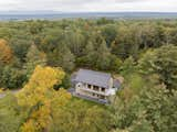 Outdoor, Woodland, Walkways, Wood Patio, Porch, Deck, Trees, Shrubs, Grass, Large Patio, Porch, Deck, and Flowers Nestled in 25 acres  Photo 10 of 14 in The Overlook by Emily Iason