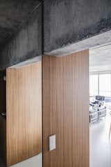 The raw concrete is offset by powerful wooden elements.