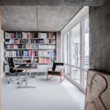 Office, Chair, Concrete Floor, Bookcase, and Library Room Type The study with Eames armchair overlooking Berlin  Photo 5 of 12 in Senso for Sitzler Berlin