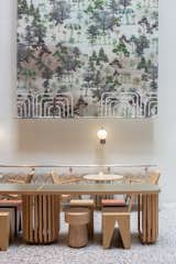 In the main atrium of Double B Hostel, a custom-made long table is paired with geometrically designed stools, all set against the seasonal banner canvas backdrop.