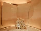 Petal shaped walls of reception area, caramel onyx reception desk carved in a shape of ancient Chinese Mei Hua character.