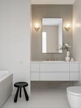 The bathroom is adorned with Appiani mosaic and CDC tiles. Gessi faucets, Arbi sink vanity, Atelier Areti wall lights, GK Concept and Marimekko vases, Cassina stool designed by Charlotte Perriand in 1961.
