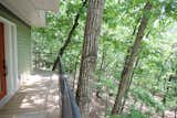 Outdoor, Wood Patio, Porch, Deck, Metal Fences, Wall, Small Patio, Porch, Deck, Woodland, Metal Patio, Porch, Deck, and Trees  Photo 5 of 9 in Secluded Ozark Mountains Treehouse by Emily Carr