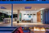 Outdoor, Hardscapes, Concrete Patio, Porch, Deck, Back Yard, and Landscape Lighting Evening gas fireplace.  Photo 9 of 11 in The Modernist Pool House by Wayne Truax