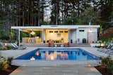 Outdoor, Hardscapes, Back Yard, Swimming Pools, Tubs, Shower, Landscape Lighting, Pavers Patio, Porch, Deck, and Concrete Patio, Porch, Deck Pool and pool house as the sun sets.  Photo 10 of 11 in The Modernist Pool House by Wayne Truax