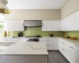 After: 2023 photo of kitchen with new tile backsplash by Ceramica VOGUE system Triangoli and Miele cooktop.