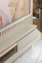 The customised TV unit detailed with a fluted pattern