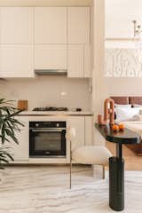 The all-white kitchen along with a two-seater dining ledge