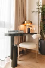 The study nook designed to overlook the window where it  can be used with good light and ventilation. The table has been customised in design to blend with the language of the space.