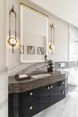 The bathroom with the customised vanity and a touch sensored mirror. The selected lights bring in a layer of interest in the otherwise blank wall above the sink.