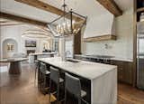 Kitchen, Mosaic Tile Backsplashe, Refrigerator, Range Hood, Range, Ceiling Lighting, Drop In Sink, and Pendant Lighting Kitchen and Living Room  Photo 11 of 23 in The Knoll House- A Tuscan Villa by J Christopher Architecture