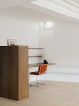 Office, Study Room Type, Shelves, Desk, Lamps, Storage, Chair, and Medium Hardwood Floor View from the living-room on the custom-made desk and its storage unit  Photo 8 of 18 in The MUSC project - an appartement in the historic heart of Paris by PAREIL