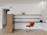 Office, Medium Hardwood Floor, Lamps, Desk, Shelves, Study Room Type, Storage, and Chair View from the living-room on the custom-made desk and its storage unit  Photo 7 of 18 in The MUSC project - an appartement in the historic heart of Paris by PAREIL