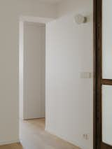 Hallway and Medium Hardwood Floor View of hallway with custom-made wooden doors leading to the small bedroom  Photo 10 of 18 in The MUSC project - an appartement in the historic heart of Paris by PAREIL