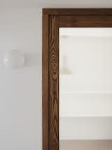 Custom-made wooden door and hallway sconce by La Quincallerie Moderne