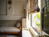 Living Room, Lamps, Table Lighting, Sofa, Table, and Terra-cotta Tile Floor Hand-crafted bamboo screen paired with block-printed chanderi silk curtains  Photo 3 of 27 in The Pot House by Tina Kedia