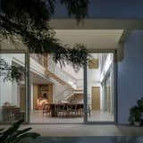 Dining Room, Light Hardwood Floor, Medium Hardwood Floor, Bench, Table Lighting, Table, Chair, Floor Lighting, Ceiling Lighting, and Standard Layout Fireplace  Photo 8 of 132 in House in CHOKCHAI 4 by Black Pencils Studio