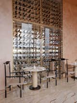 Custom wine chiller displays on the right are complimented with dining groups in a chinoiserie style.
