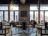 Panoramic windows open up to a breathtaking view of the mountains.