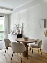Dining Room, Table, Light Hardwood Floor, Chair, and Wall Lighting Dining area. The round table is made of natural wood.  Photo 8 of 20 in Charming apartment with a touch of Bali's serenity by Maria Ushakova by Anna Maria Abara