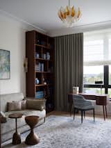 Office, Light Hardwood Floor, Lamps, Study Room Type, Desk, Chair, and Bookcase Home office that can be used as a guest room.  Photo 14 of 16 in Stylish French-inspired apartment in Moscow by Anna Maria Abara