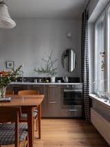 Kitchen, Medium Hardwood Floor, Ceramic Tile Backsplashe, Wall Oven, and Metal Cabinet  Photo 8 of 19 in The graphic apartment of 40 sqm by decorator Margo Terentyeva by Anna Maria Abara