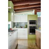 The elongated tile backsplash mirrors the brick that dons the exterior and interior walls.