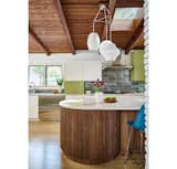 A trio of Nelson Bubble pendants are hung in a cluster style over the island.