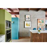 A custom shelving nook was built into the brick wall where the wall oven used to sit.