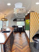 Office, Chair, Study Room Type, Medium Hardwood Floor, Storage, Library Room Type, Bookcase, Lamps, Desk, and Shelves  Photo 5 of 5 in The Farmhouse Office Airstream by Wood & Locks