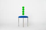 Duality Chair
The chair is made from a raw steel base with light patina topped with royal blue colored upholstered seat with scalloped edges and a backrest made of circular elements from green lacquered wood.
