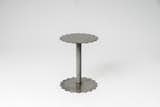 Duality Side Table
The Duality side table is made of steel sheet with traces of light surface patina with shiny lacquered finish.
The table has a strong industrial appeal that is soften with detailing of scalloped edges both at the top and bottom.  
